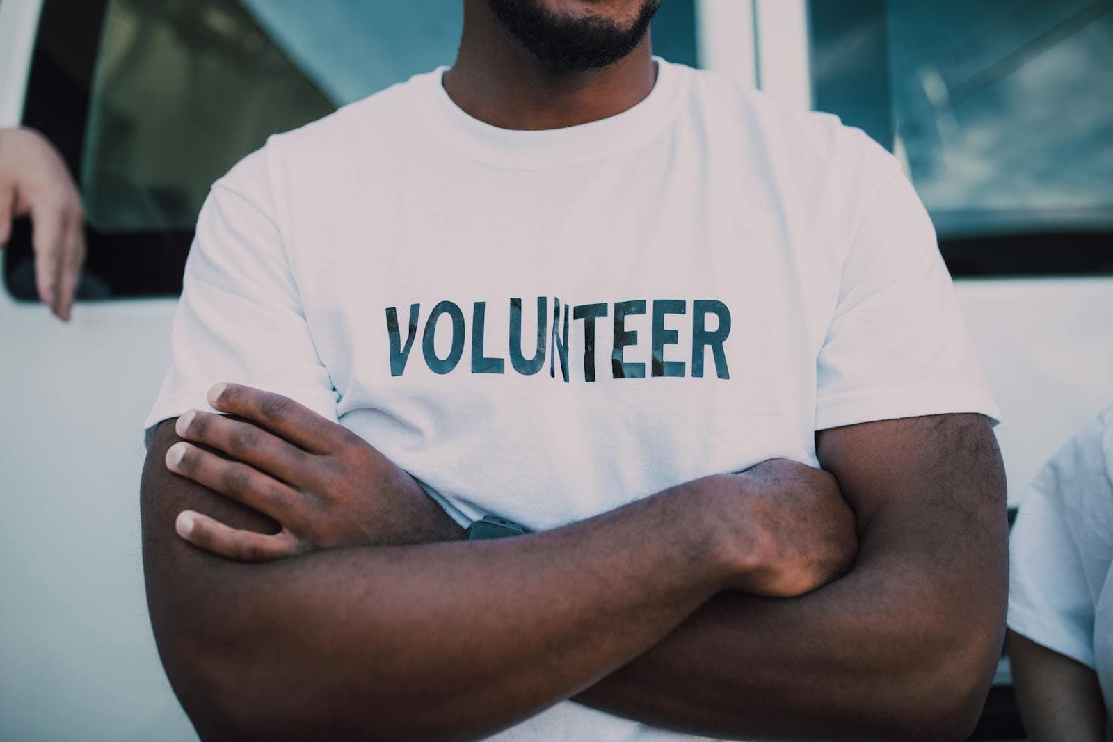 A volunteer in a white shirt