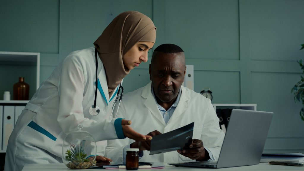 Multiracial doctors colleagues discuss teamwork african man and arabian woman two professional