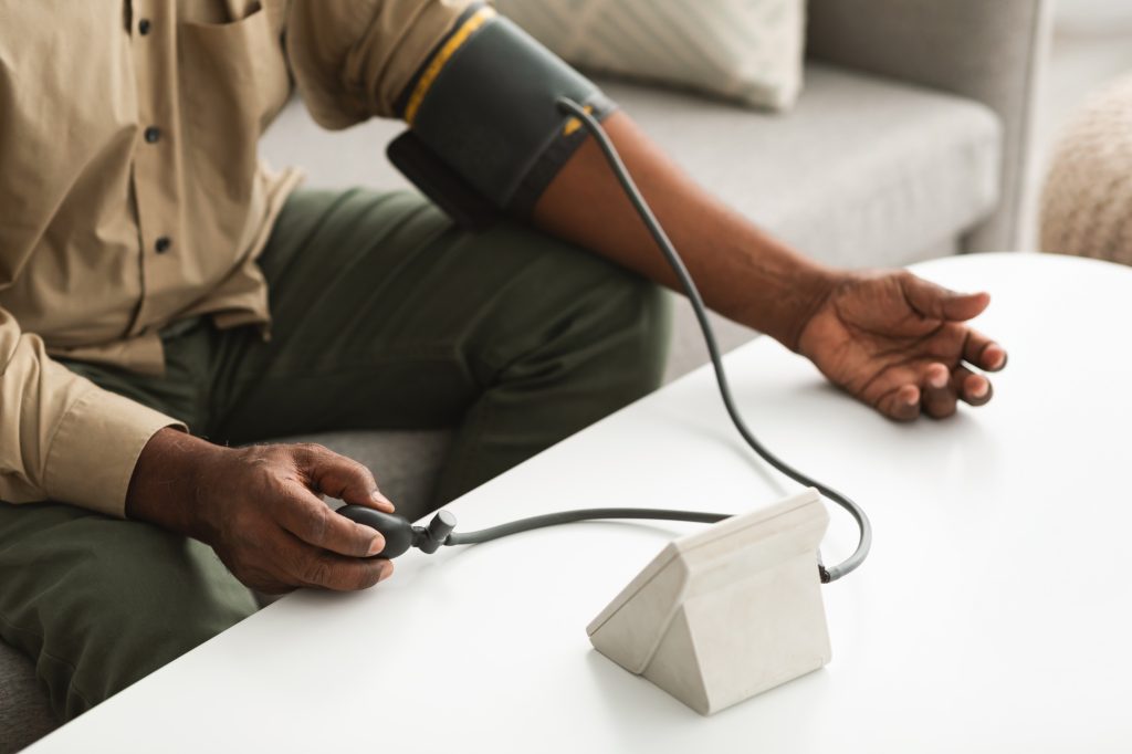 Unrecognizable African American Man Measuring Blood Pressure At Home, Cropped